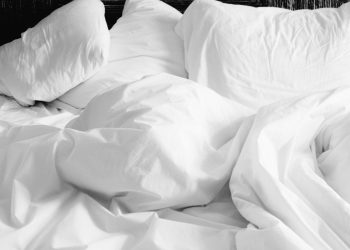 pillows and white linen sheets