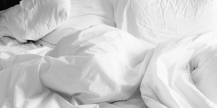 pillows and white linen sheets