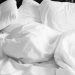 pillows and white linen sheets
