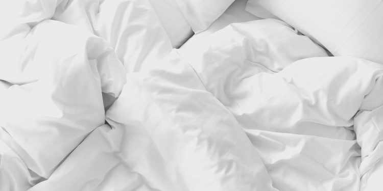 white bed with a mattress