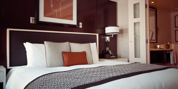 black and grey bedspread on bed and pillow