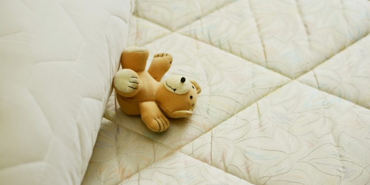 mattress with teddy bear on it